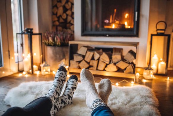Wool socks warming by a lit fireside